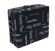 Faltmatratze 190 x 70 cm in gefaltetem Zustand mit schwarzem Bezug und Schriftzügen, seitliche Perspektive