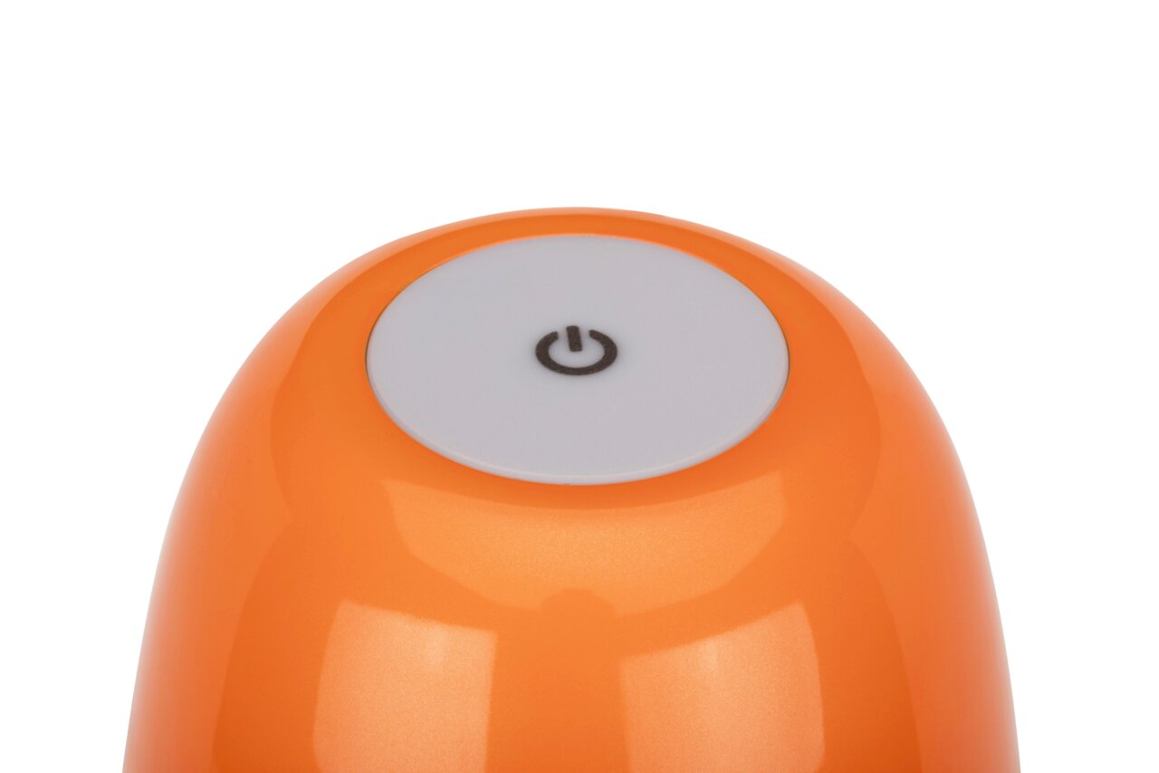 Close-up van een oranje accu-tafellamp met een witte aan/uit-schakelaar aan de bovenkant.