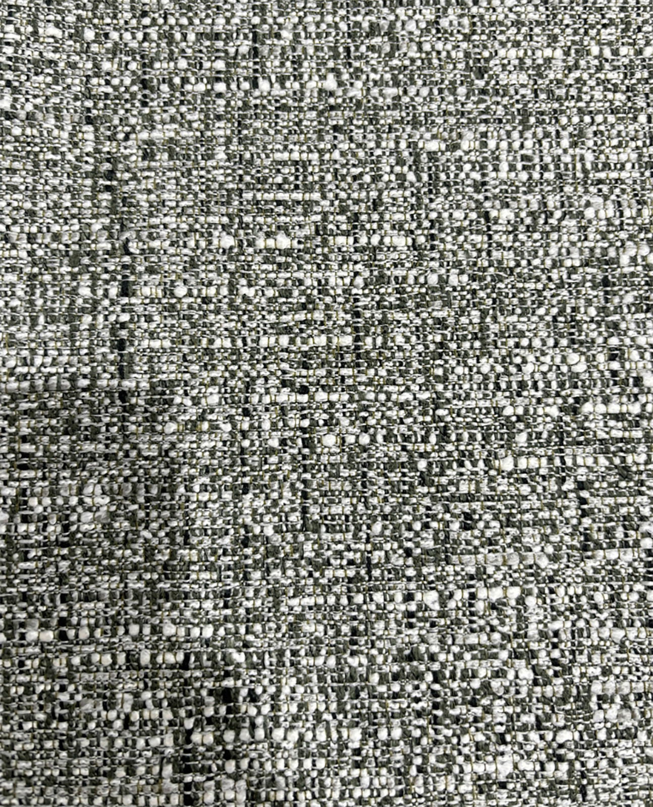 Nahaufnahme eines strukturierten Stoffes in Grau- und Weißtönen, verwendet für einen Armlehnstuhl