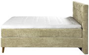 Seitenansicht eines Boxspringbetts 180x200 cm mit beigem Stoffbezug und gepolstertem Kopfteil.