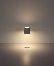 Moderne Tischleuchte mit schlichtem Design, frontal abgebildet, strahlt warmes Licht aus.