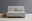 Graues Funktionssofa mit zwei passenden Kissen, frontal fotografiert, neben einem Korb mit Glas und Schale.