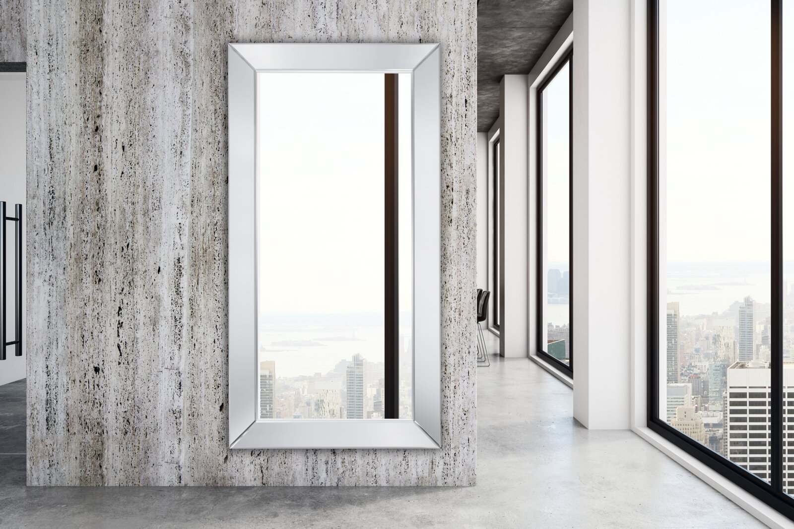 Großer rechteckiger Spiegel mit silbernem Rahmen, an einer modernen Betonwand montiert, mit Blick auf eine Stadtlandschaft durch große Fenster.