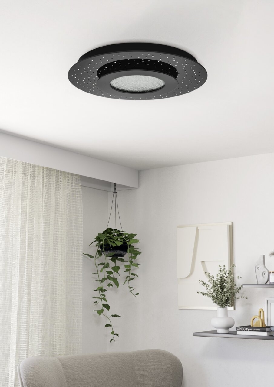 Moderne schwarze LED-Deckenleuchte mit sternenähnlichen Mustern, von unten betrachtet in einem stilvoll eingerichteten Raum.