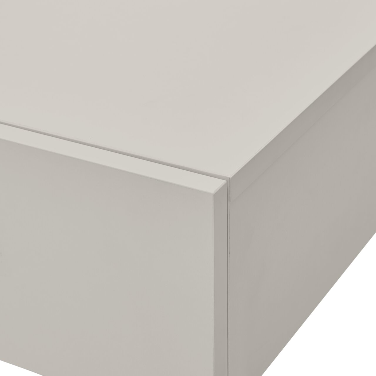 Close-up van een witte wandconsole met strakke lijnen en een glad oppervlak, gefotografeerd vanuit perspectief van rechtsboven.