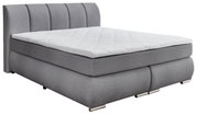 Graues Boxspringbett mit gestepptem Kopfteil, seitliche Perspektive