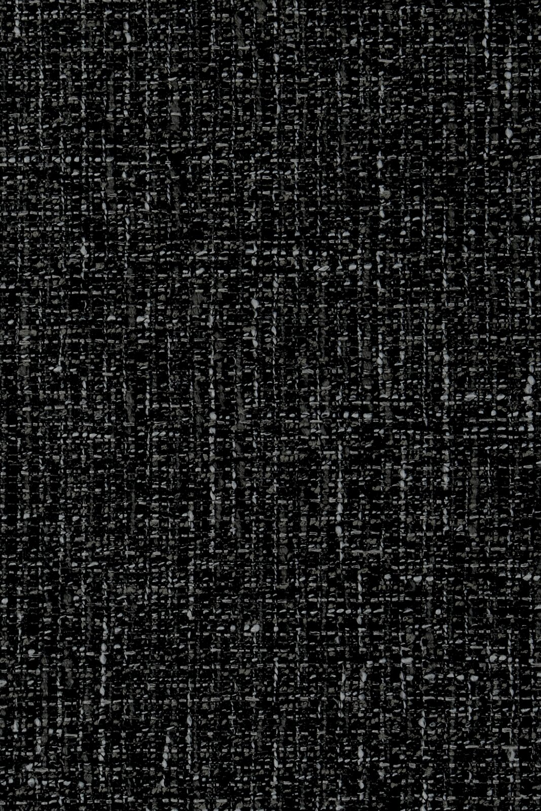 Close-up van een donkergrijze, gestructureerde stof die wordt gebruikt voor een fauteuil.