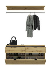 Kommode aus Holz mit offenen Schubladen, gefüllt mit Schuhen, und einer Ablagefläche mit Handtasche und Brille. Darüber eine Kleiderstange mit hängenden Mänteln. Frontale Perspektive.