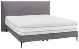 Boxspringbett mit grauem Stoffbezug und weißer Matratze, seitliche Perspektive