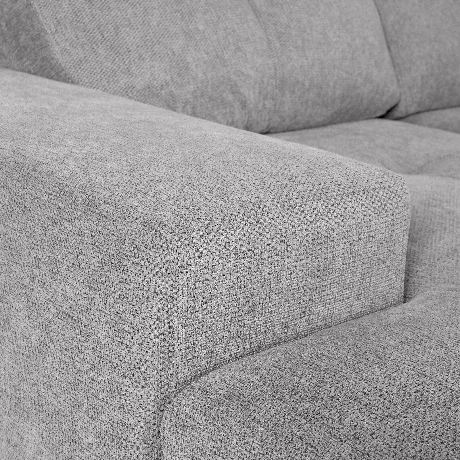 Nahaufnahme einer grauen Stoff-Rundecke mit Armlehne, Perspektive von der Seite.