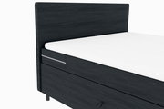 Boxspringbett in dunklem Stoff mit weißer Matratze, seitliche Perspektive