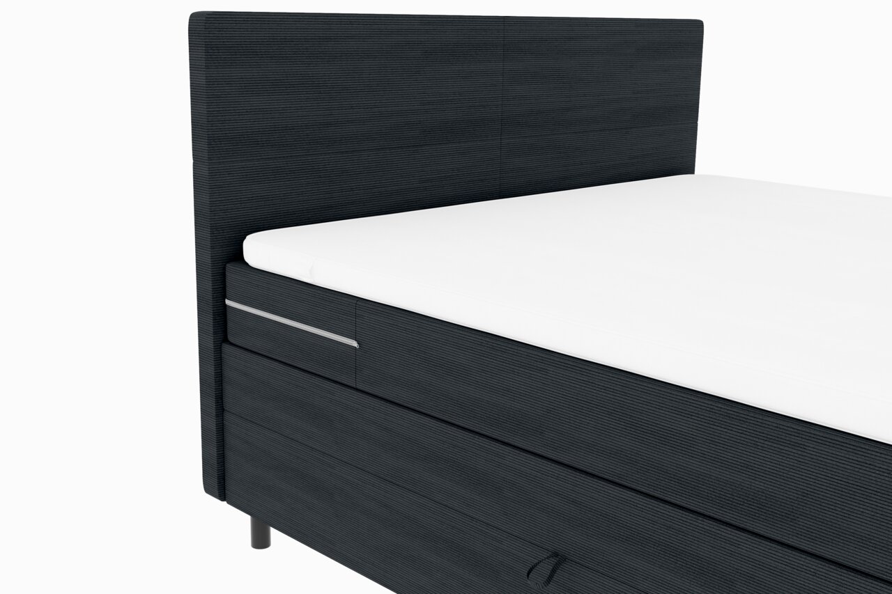 Boxspringbett in dunklem Stoff mit weißer Matratze, seitliche Perspektive