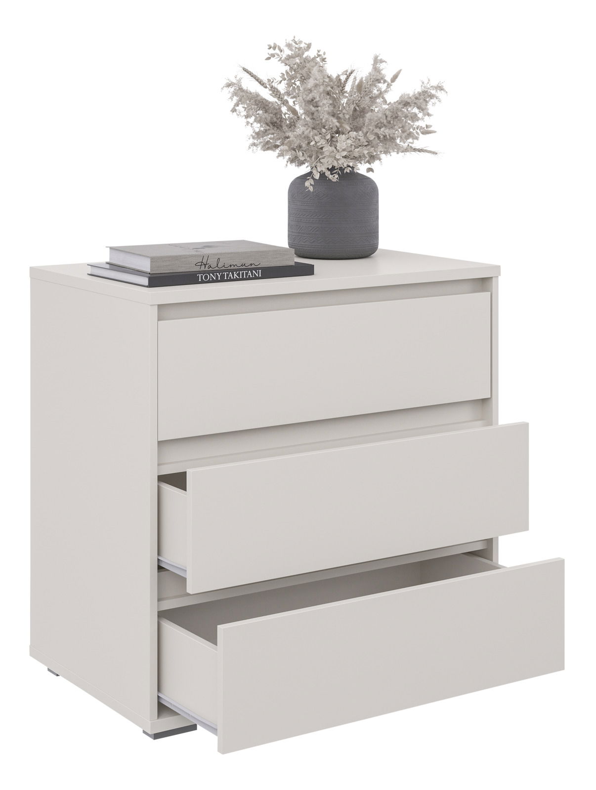 Weiße Kommode mit drei Schubladen, zwei davon geöffnet, dekoriert mit einem grauen Blumentopf und Büchern, seitliche Perspektive