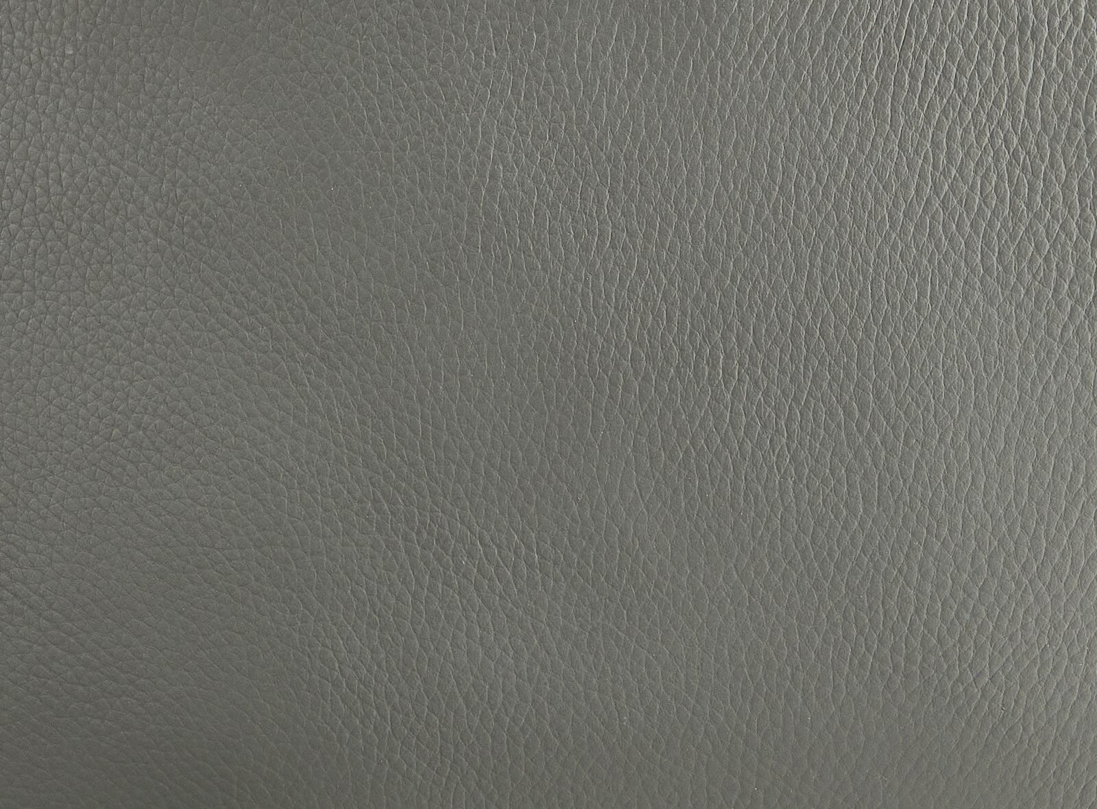 Nahaufnahme einer grauen Lederstruktur, verwendet für einen Armlehnstuhl.