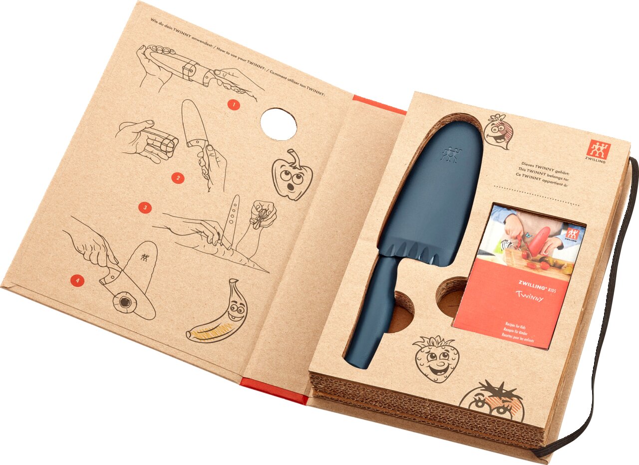 Kinderkochmesser 10 cm in Blau, präsentiert in einer offenen Verpackung mit Anleitungen und kindgerechten Illustrationen, aus der Vogelperspektive.