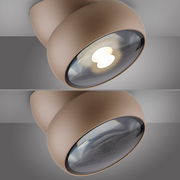 Moderne LED-Deckenleuchte in Nahaufnahme, seitliche Perspektive, mit rundem, braunem Gehäuse und leuchtendem LED-Licht.