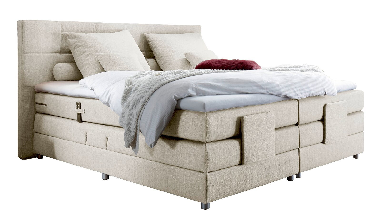 Esposa Boxspringbett MANOLO Beiges Boxspringbett mit Kopfteil, seitlicher Perspektive, dekoriert mit Kissen und Decken.