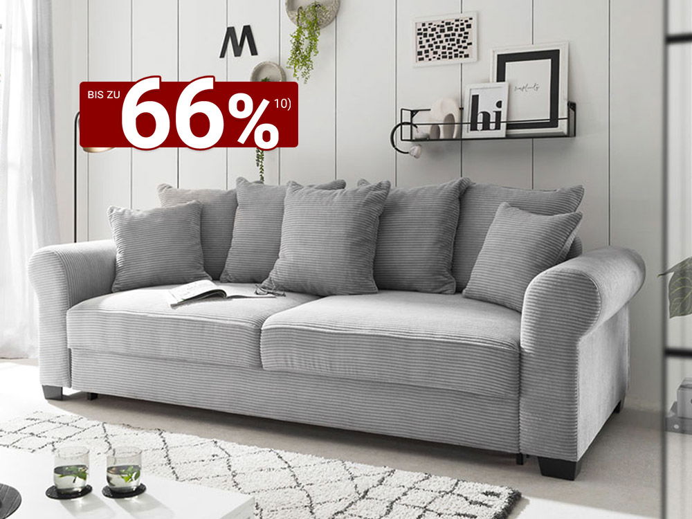 Modernes graues 3-Sitzer-Sofa mit Cordbezug und Kissen vor weißer Wandpaneel-Optik im skandinavischen Wohnzimmer.