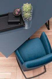 Freischwinger-Sessel in Blau aus der Vogelperspektive neben einem Tisch mit Dekoration.
