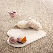 Kinderzimmerteppich in Herzform mit Spielzeug, aus der Vogelperspektive fotografiert