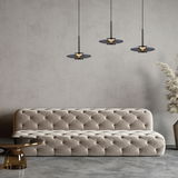 Drei moderne Pendelleuchten PURE Vitrum in einem eleganten Wohnzimmer, frontal betrachtet, über einem stilvollen, gepolsterten Sofa.