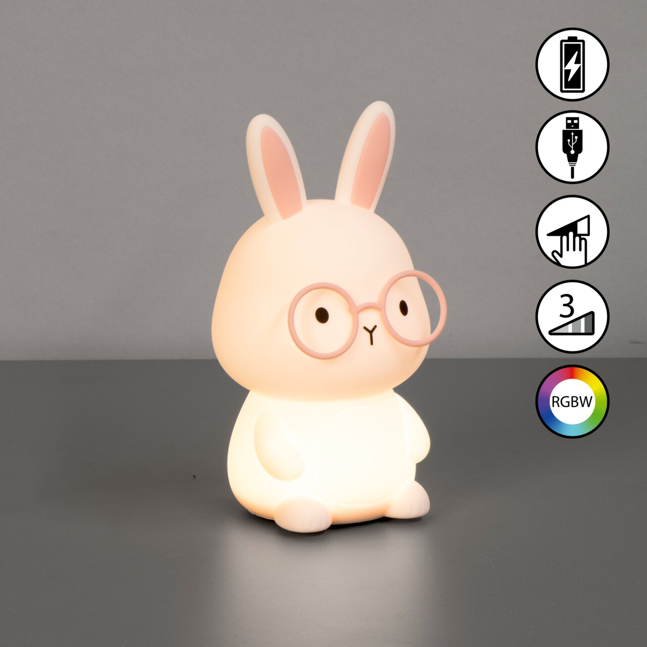 Niedliches Akku-Nachtlicht in Form eines Hasen mit Brille, von vorne betrachtet. Es leuchtet sanft und bietet RGBW-Farboptionen sowie eine USB-Ladefunktion.