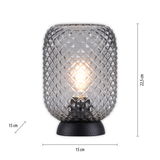 Tischleuchte mit strukturiertem Glasdesign, beleuchtet, auf schwarzem Sockel, frontal betrachtet.