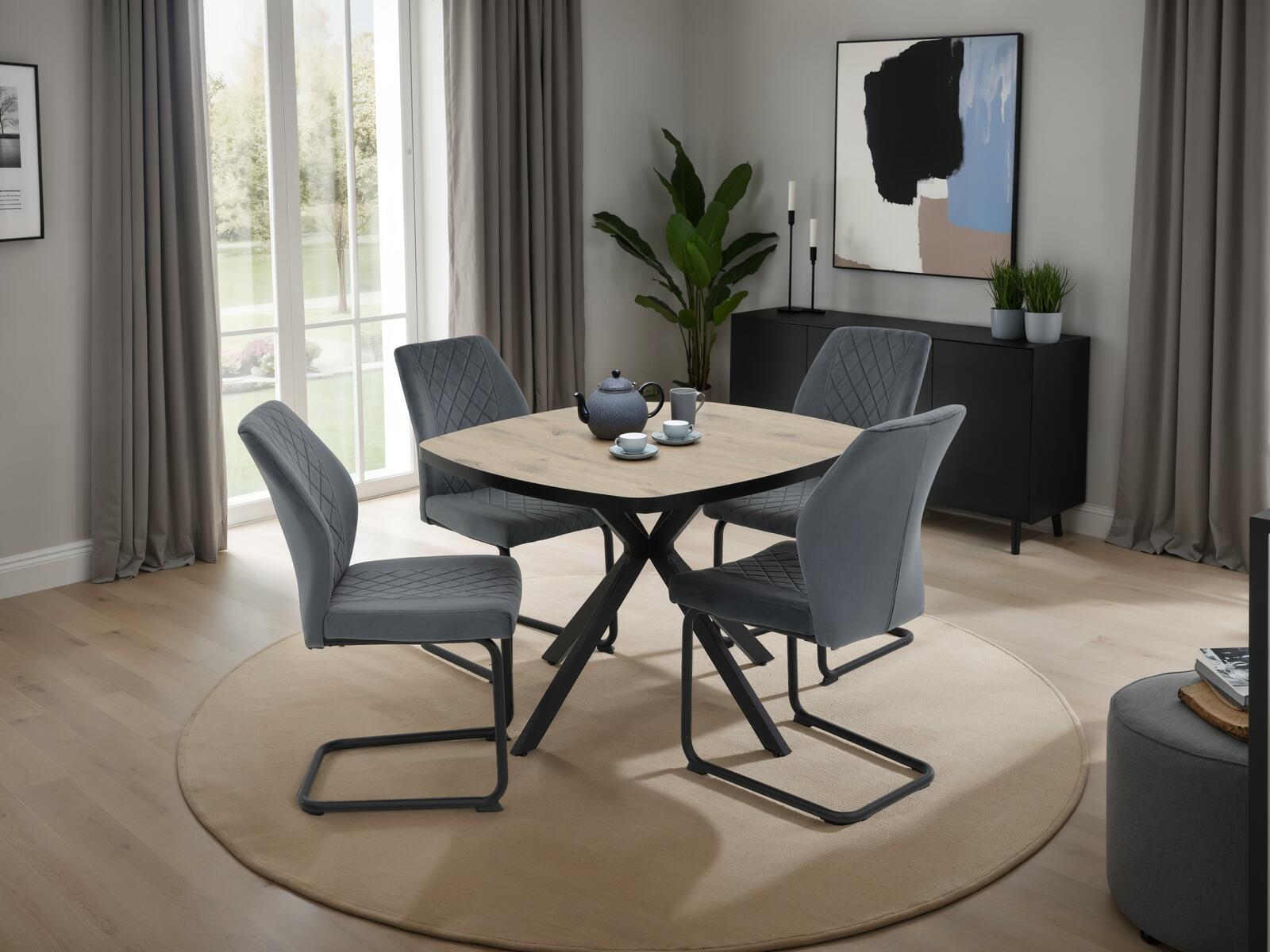 Z2 Schwingstuhl OSLO Moderner Essbereich mit vier grauen Schwingstühlen um einen runden Holztisch, seitliche Perspektive.