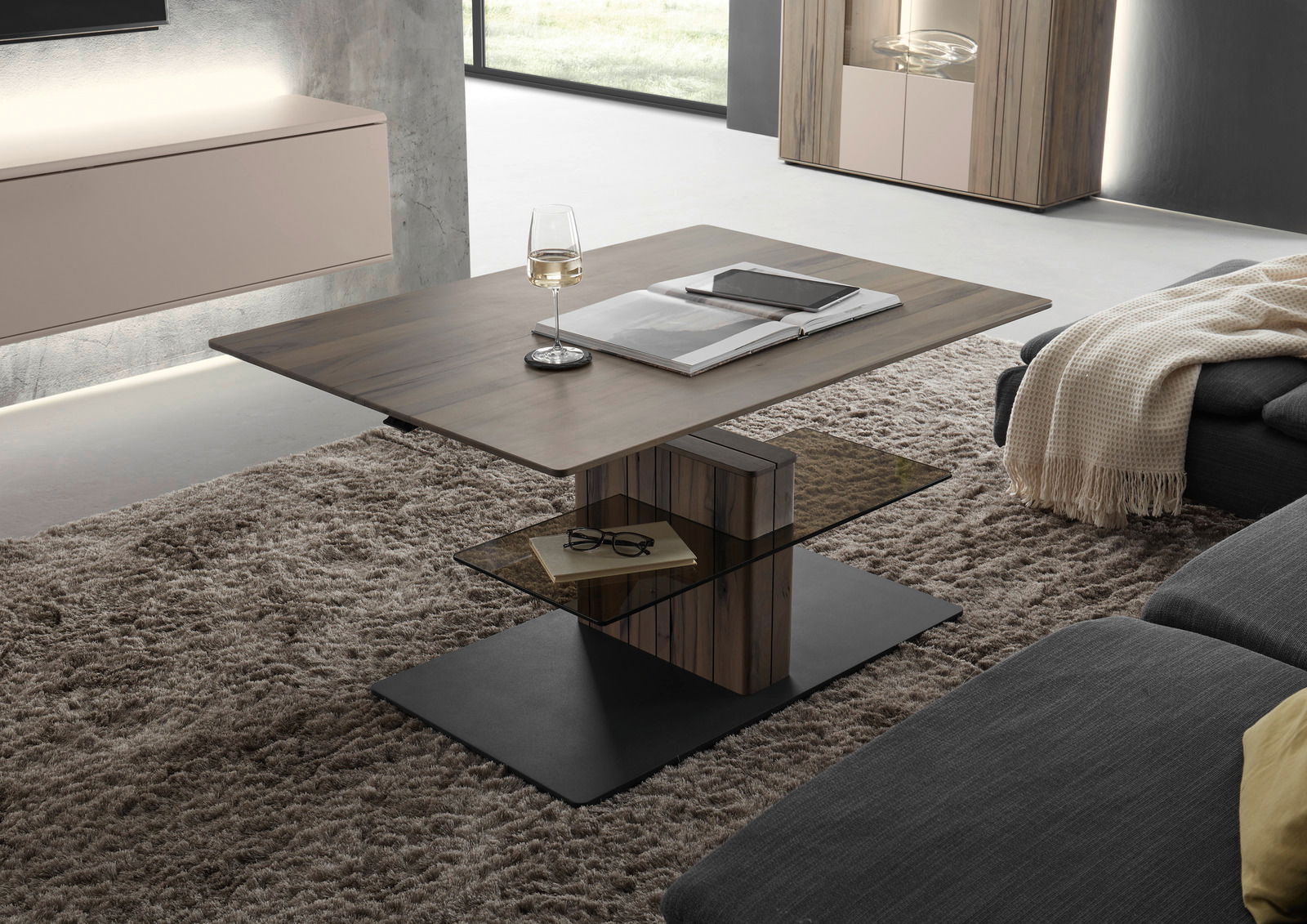 Moderner Couchtisch mit Holz- und Glaselementen, seitliche Perspektive, auf einem Teppich in einem stilvollen Wohnzimmer platziert.