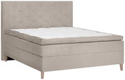 Beiges Boxspringbett mit gestepptem Kopfteil, seitliche Perspektive