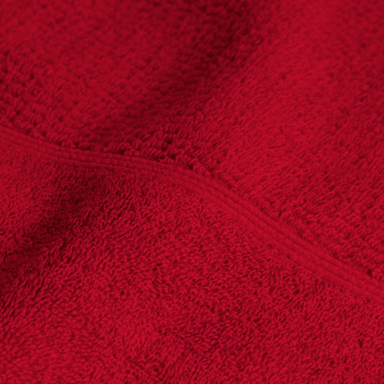Close-up van een rode handdoek uit de 4-delige Ruby-set, waarop de zachte textuur en het materiaal goed te zien zijn.