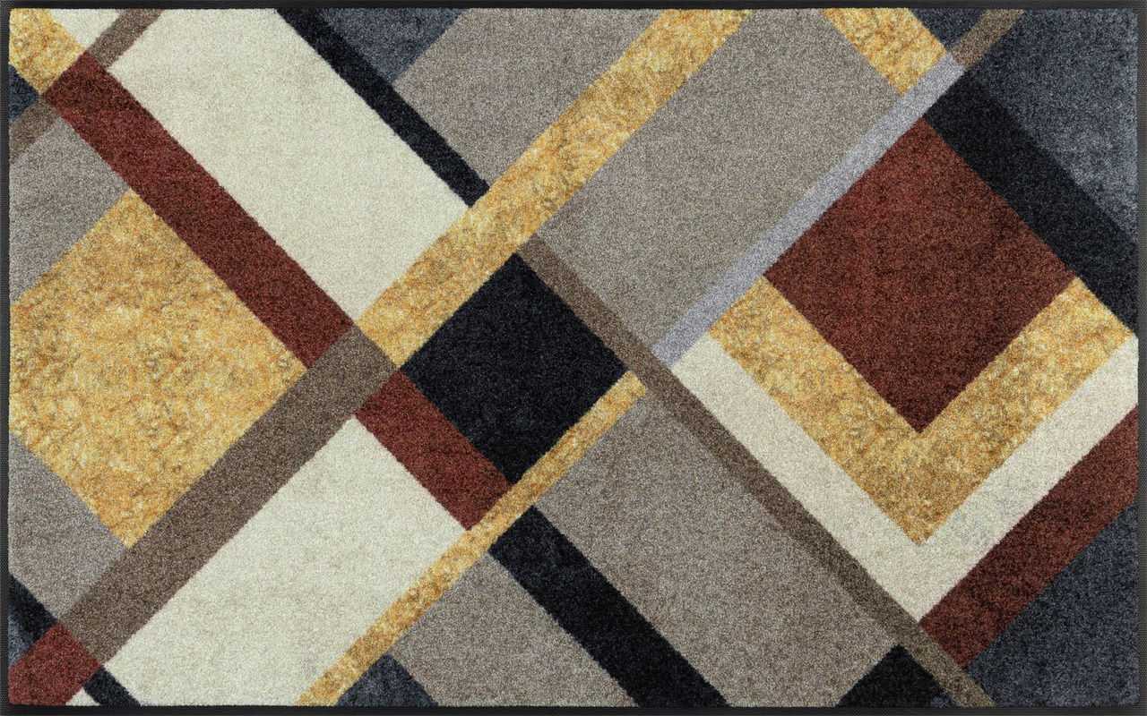 Fußmatte im Art Deco Stil mit geometrischem Muster in verschiedenen Farben, aus der Vogelperspektive betrachtet.