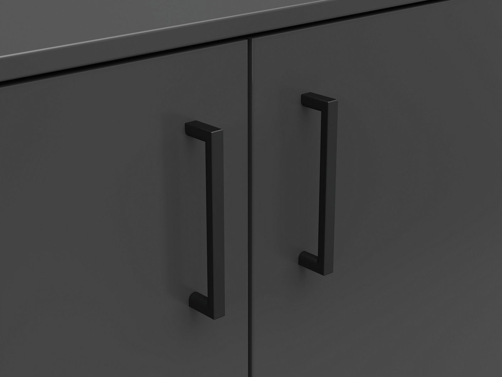 Nahaufnahme einer dunklen Kommode mit zwei schwarzen Griffen, Frontalansicht.