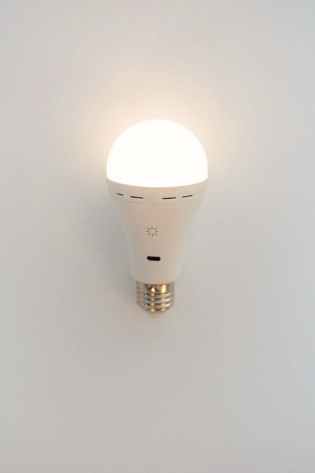 Akkubetriebene LED-Glühbirne, frontal an der Wand montiert, mit leuchtendem Licht.