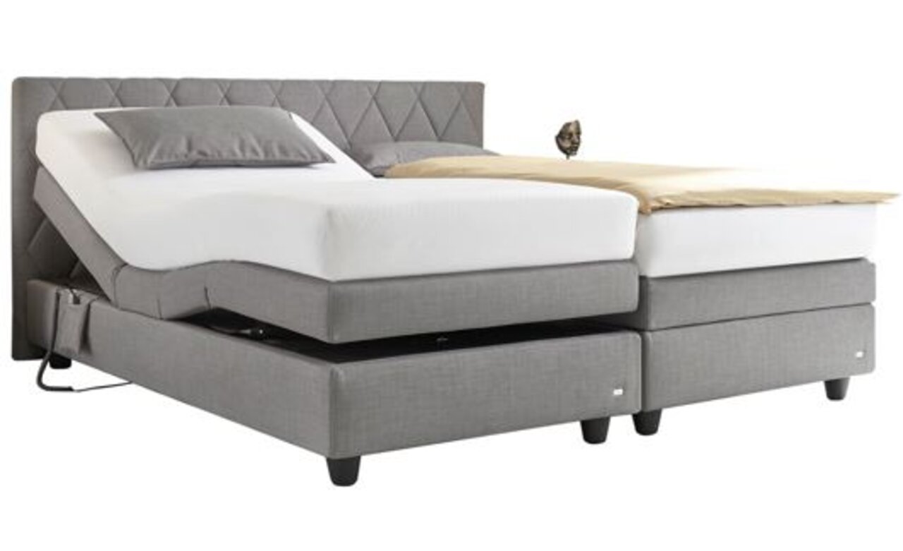 Graues Boxspringbett mit verstellbaren Matratzen, seitliche Perspektive