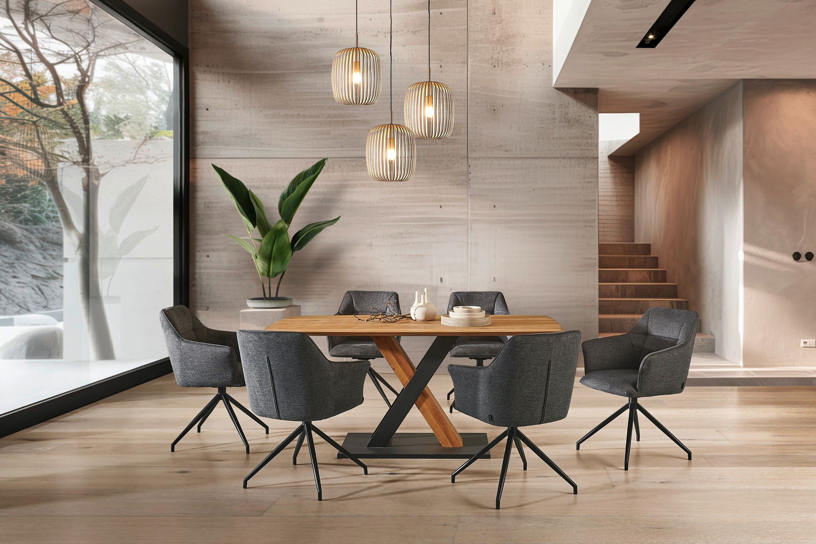 Moderner Esstisch mit Holzplatte und Metallgestell, umgeben von sechs grauen Stühlen in einem stilvollen Esszimmer mit Blick auf eine Treppe und große Fenster. Perspektive: Frontalansicht.