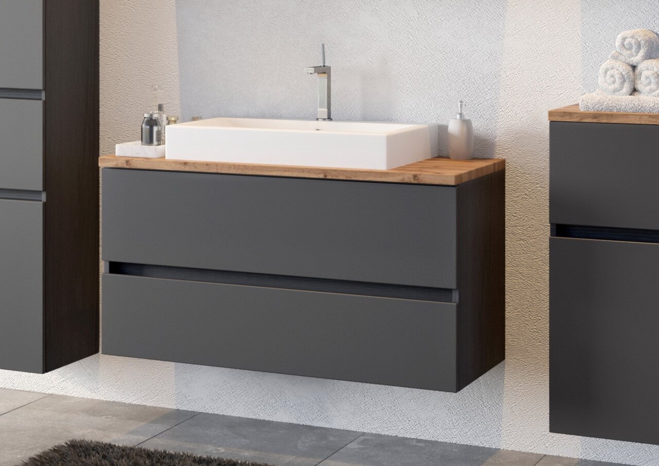 Moderne wastafelcombinatie met grijze kast en witte wastafel, zijaanzicht