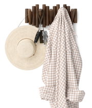 Wandgarderobe aus Holz mit Hüten, Schlüsseln und einem karierten Hemd, frontal betrachtet.