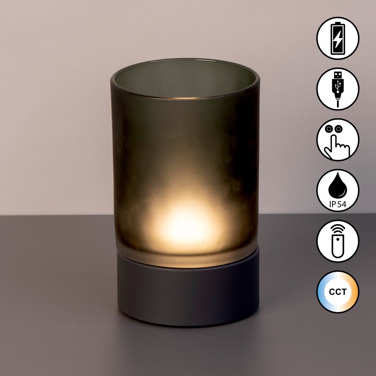 Akku-Windlicht mit zylindrischem, mattem Glas und dunklem Sockel, frontal fotografiert. Symbole für USB-Ladung, Touch-Bedienung, IP54-Schutz, Fernbedienung und CCT-Farbtemperaturregelung sind sichtbar.