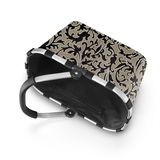 Carrybag mit floralem Muster, von oben betrachtet, mit stabilem Aluminiumrahmen und schwarzem Griff.