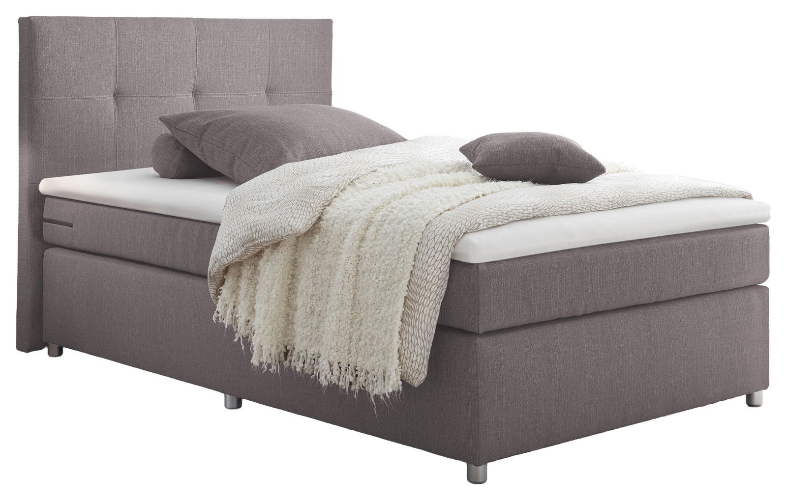 Boxspringbett in seitlicher Perspektive mit grauem Stoffbezug, Kopfteil mit quadratischer Steppung, und dekorativen Kissen und Decke.