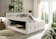 Boxspringbett mit Stauraum in einem hellen Schlafzimmer, seitliche Perspektive