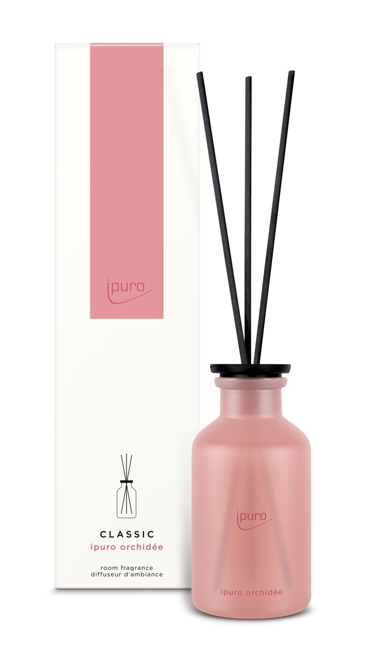 Ipuro Classic Orchidee Raumduft mit rosa Flasche und schwarzen Duftstäbchen, frontal abgebildet neben der Verpackung.