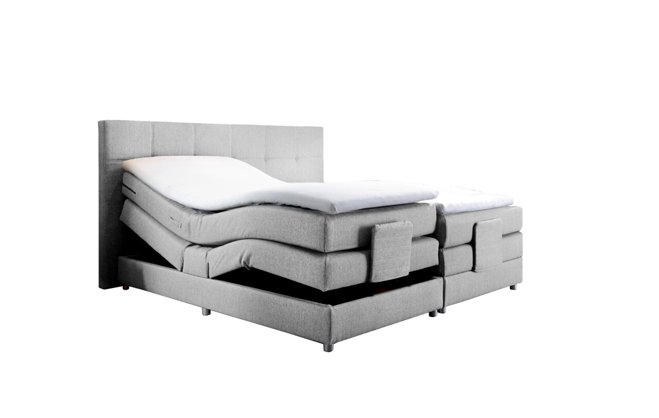Graues Boxspringbett mit verstellbaren Matratzen, seitliche Perspektive