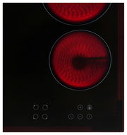 Glaskeramikkochfeld mit zwei leuchtenden Kochzonen und Bedienelementen in der Vorderansicht