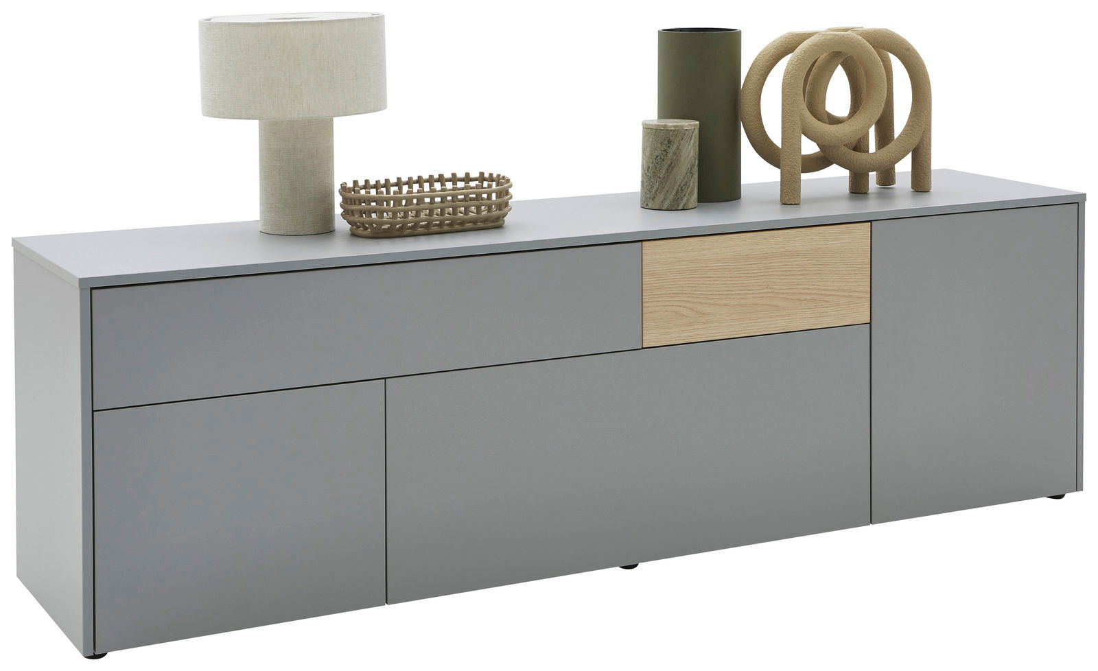 Modernes TV-Lowboard in Grau mit Holzakzent, dekoriert mit einer Tischlampe, einem Korb und weiteren Accessoires, seitliche Perspektive.