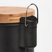 Nahaufnahme eines schwarzen Kosmetikeimers mit Holzdeckel und Metallgriff