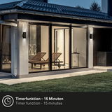 Moderne Akku-Außenwandleuchte an einer Hauswand in der Abenddämmerung, seitliche Perspektive