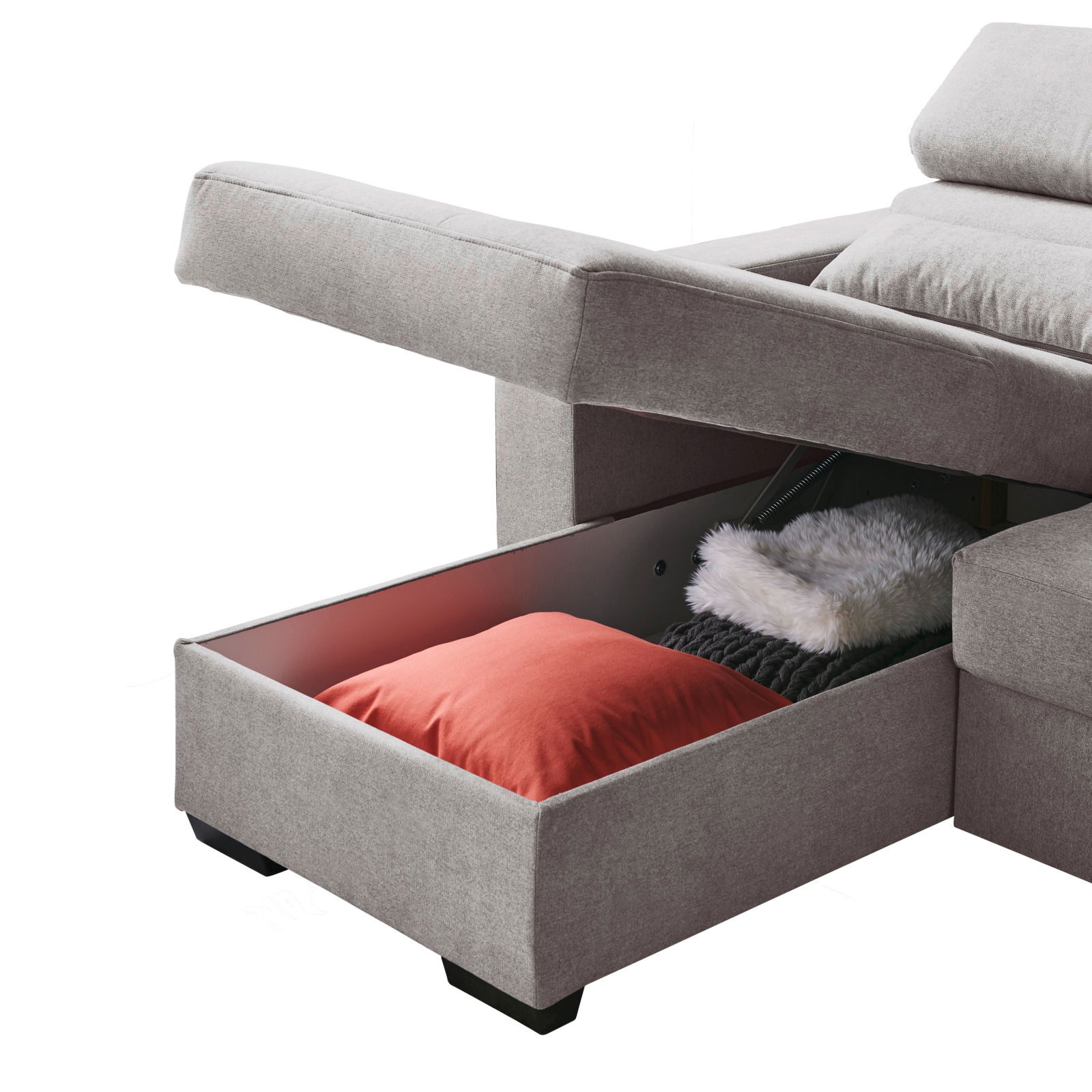 Graues Sofa mit geöffneter Aufbewahrungsschublade, die ein rotes Kissen und eine weiße Decke enthält, seitliche Perspektive.