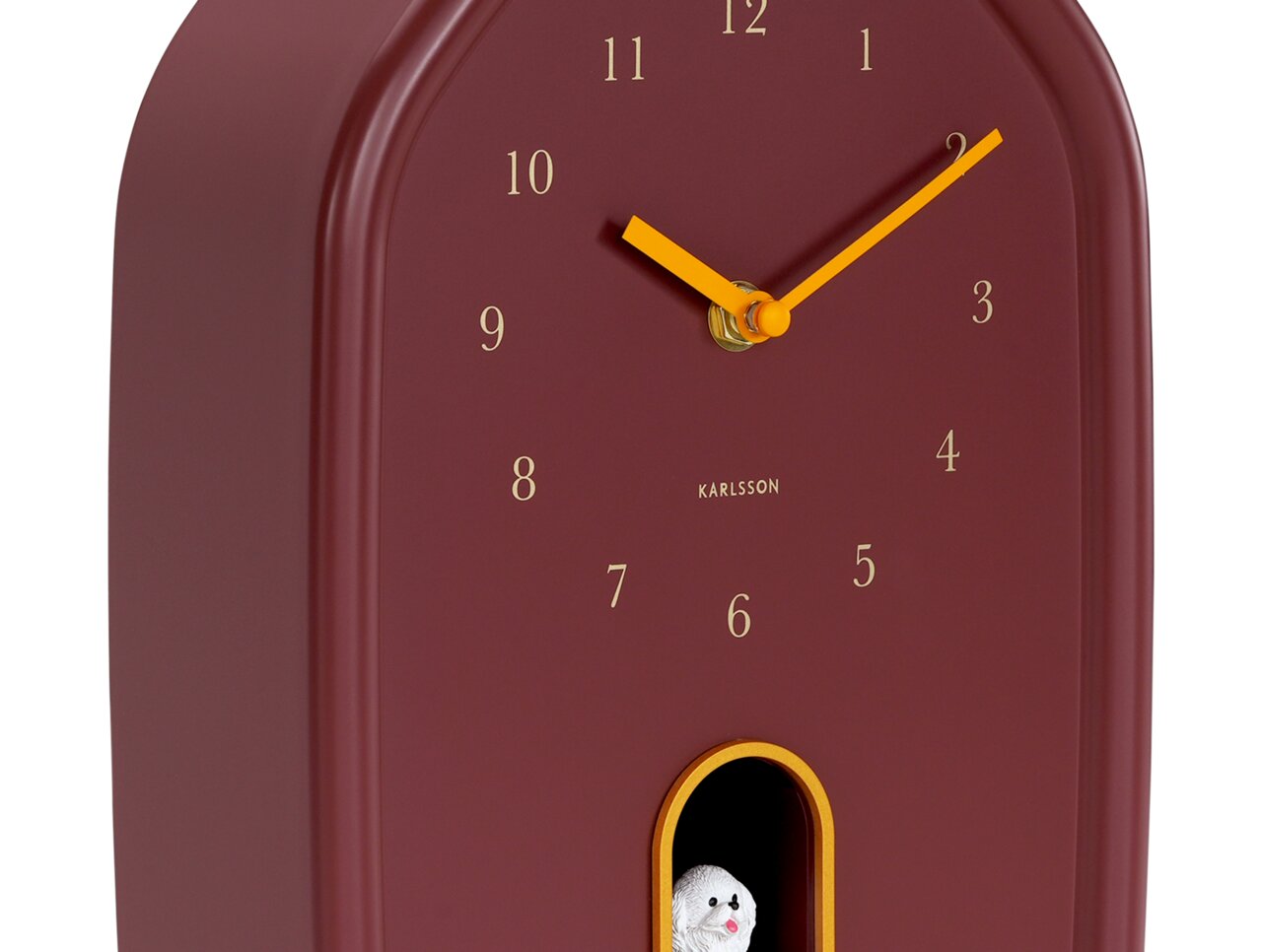 Moderne Wanduhr in Rot mit goldenen Zeigern und Zahlen, seitliche Perspektive, mit kleinem Fach und dekorativer Figur.